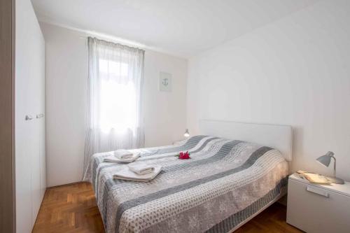 een slaapkamer met een bed met twee handdoeken erop bij Apartments in Umag - Istrien 26717 in Umag