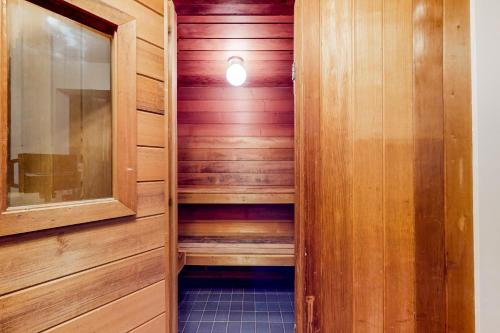 東史特拉斯堡的住宿－Whispering Woods，一间设有木镶板和灯光的桑拿浴室