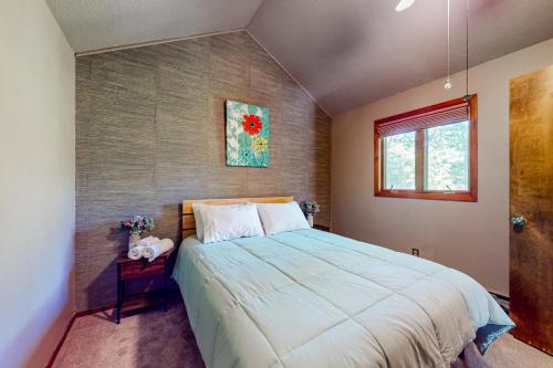 a bedroom with a large bed and a window at Whispering Woods in East Stroudsburg