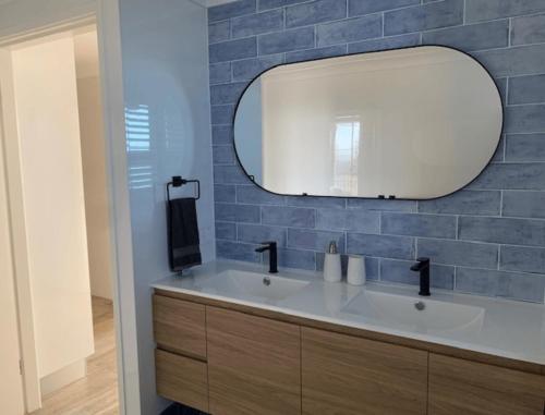 a bathroom with a white sink and a mirror at Pinnacle 701 in Forster