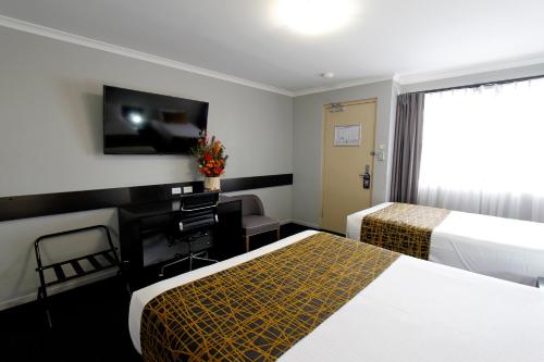 Ένα ή περισσότερα κρεβάτια σε δωμάτιο στο The Stirling Motel