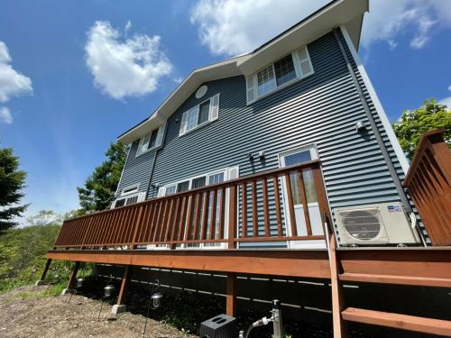 a house with a deck on top of it at ポーラーリゾート あさまテラス 1 in Oiwake