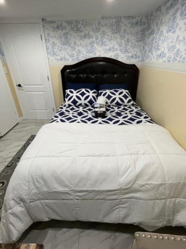 a bedroom with a large bed with blue and white patterns at A cool unique place from home in Elmont