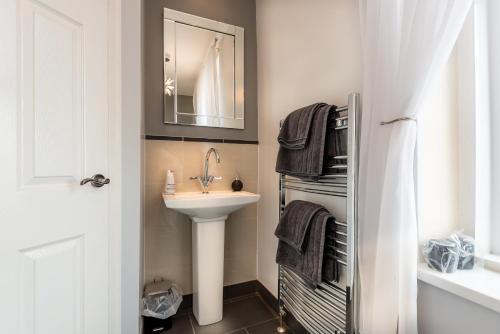 a bathroom with a sink and a mirror at Glen Guest House in Blackpool