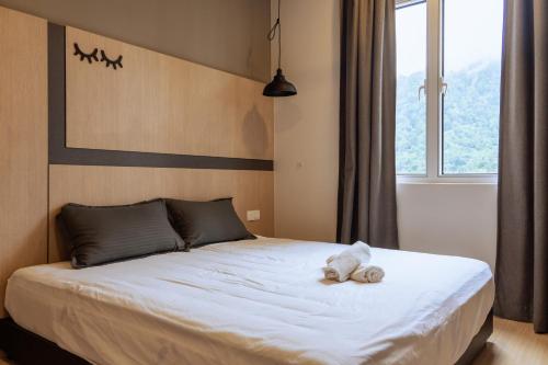 a bedroom with a bed with a stuffed animal on it at Windmill Upon Hills Premium Suite By Rapi Stay in Genting Highlands