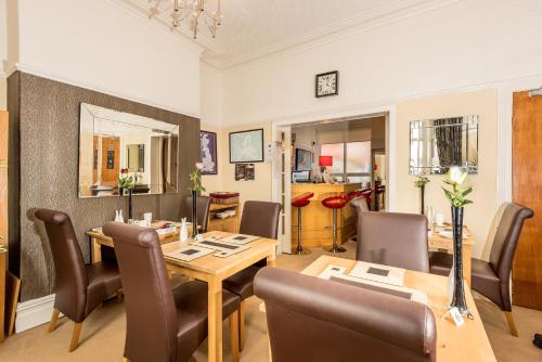 a dining room with a table and chairs at Glen Guest House in Blackpool