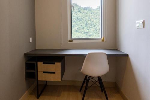 a desk with a chair in front of a window at Windmill Upon Hills Premium Suite By Rapi Stay in Genting Highlands