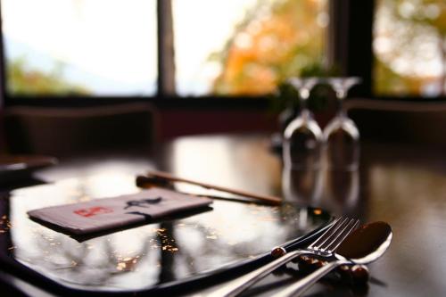 a table with a fork and a napkin on it at Ame no Hi to Yuyake-Adult Only in Chitose
