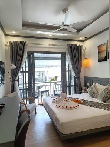 a bedroom with a large bed and a balcony at LuangPrabang Pearl Hotel in Luang Prabang