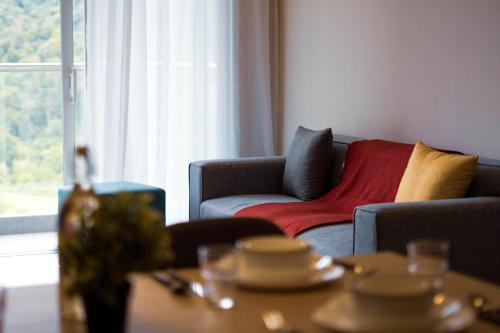 a living room with a couch and a table at Windmill Upon Hills Premium Suite By Rapi Stay in Genting Highlands