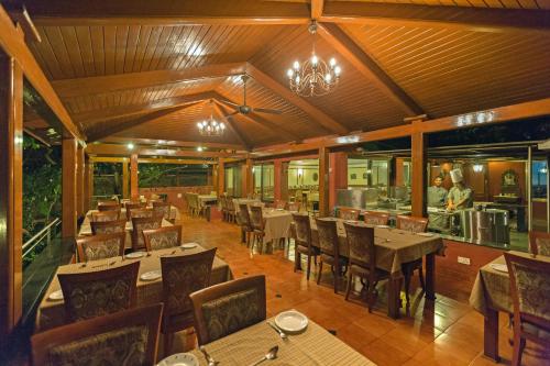 a dining room with tables and chairs and a restaurant at Ramsukh Resorts and Spa in Mahabaleshwar
