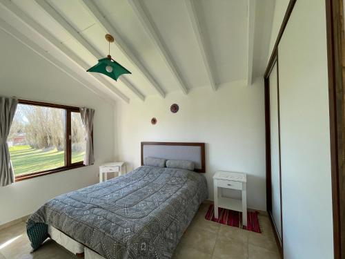 a bedroom with a bed and a large window at Viento y montaña in San Carlos de Bariloche