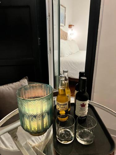 two bottles of beer on a glass table with a mirror at La Casa del Viajero in Lima