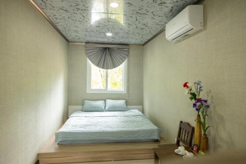 a bed in a room with a window at Halo Retreat in Hòa Bình