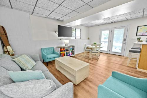 a living room with a couch and a table at 120 Creel Home away from Home for 22 at the Lake in Linn Creek