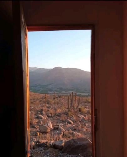 a view of a desert through a window at Casa del viento in Vicuña
