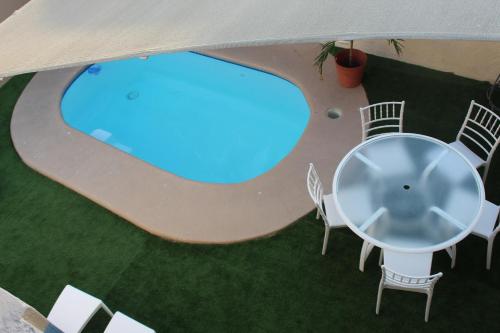 an overhead view of a table and chairs and a pool at Villa Amanecer! in Isla Mujeres