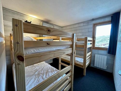 two bunk beds in a room with a window at Appartement La Plagne, 2 pièces, 6 personnes - FR-1-351-75 in La Plagne