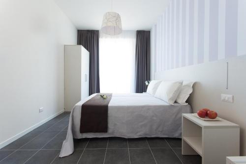 a bedroom with a bed and a large window at Hotel Star in Cesenatico