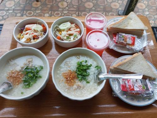 a table with bowls of soup and bowls of food at Anantra Pattaya Resort in Pattaya