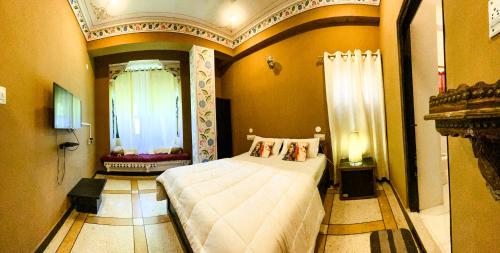 a bedroom with a large bed in a room at Hotstel Udaipur in Udaipur