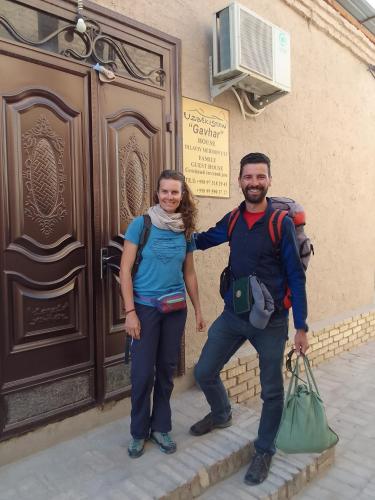 a man and a woman standing in front of a building at Gavhar House in Khiva