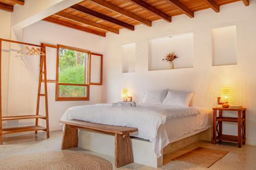 a bedroom with a bed and a ladder and a window at Hotel Auen Posada Andina in La Unión