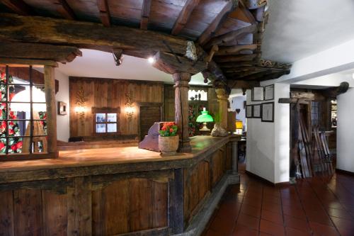 a kitchen filled with furniture and a fireplace at Hotel Milleluci in Aosta