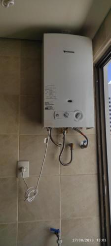 a shower in a bathroom with a machine on the floor at Vive tu experiencia en la Altura in La Paz