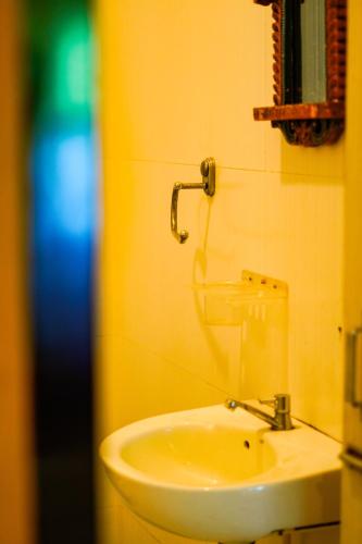 a bathroom with a sink and a faucet at Hotstel Udaipur in Udaipur