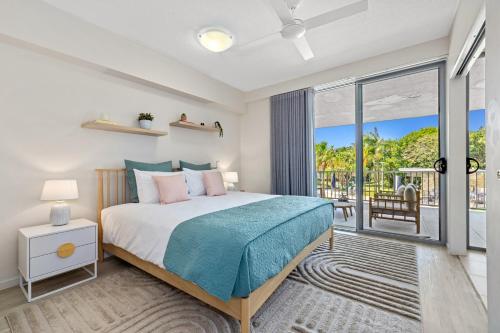 a bedroom with a bed and a balcony at Drift Apartments - Tweed Coast Holidays ® in Kingscliff