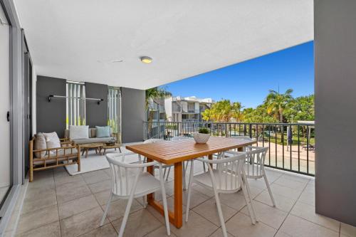 a dining room with a table and chairs and a balcony at Drift Apartments - Tweed Coast Holidays ® in Kingscliff