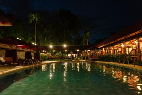 a swimming pool at night in a resort at Spatel d'Annam - Imperial Boutique Spa & Hotel in Hue