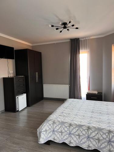 a bedroom with a bed and a ceiling fan at Polyanskiy Zamok in Polyana