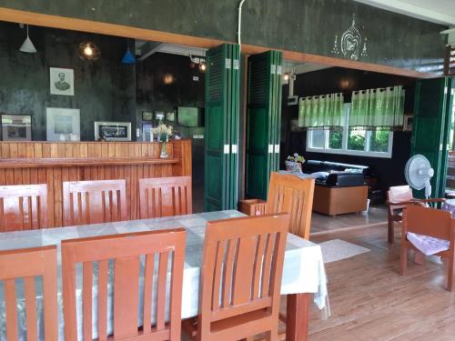 a restaurant with a table and chairs and a couch at My Home @ Wang Yao in Ban Tha Sai (1)
