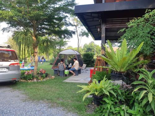 a group of people sitting in a tent in a yard at My Home @ Wang Yao in Ban Tha Sai (1)