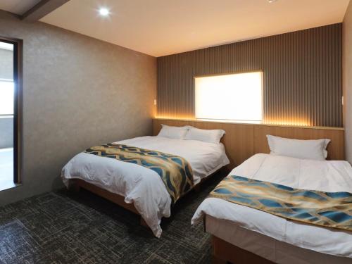 Una cama o camas en una habitación de Kurobe Sunvalley Hotel
