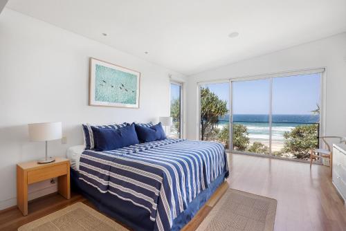 a bedroom with a bed with a view of the ocean at 38 Seaview Terrace, Sunshine Beach in Noosa Heads