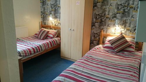 Ένα ή περισσότερα κρεβάτια σε δωμάτιο στο Tulip Hotel Blackpool