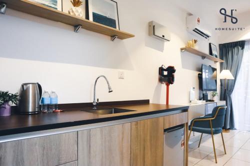 a kitchen with a sink and a counter top at Homesuite' Home at Aeropod SOVO in Kota Kinabalu