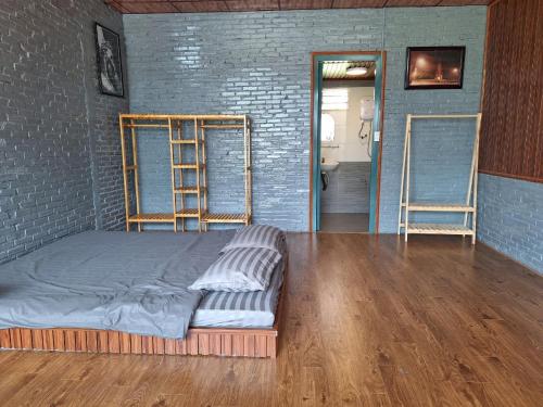 a room with a bed and two ladders in it at Windy Home in Ấp Man Ling