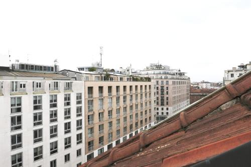 a view of a city with tall buildings at ComeCasa Prestigioso Attico in Duomo - San Babila in Milan