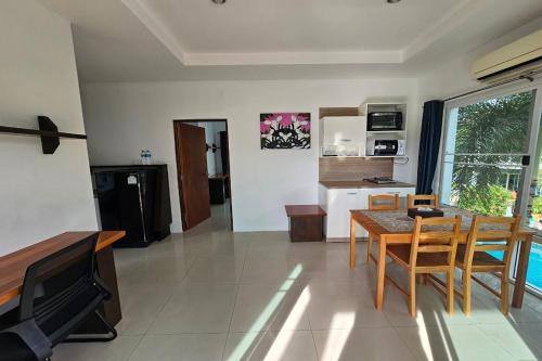 a living room with a table and a dining room at The One Cozy Vacation Residence SHA Hotel in Chalong 