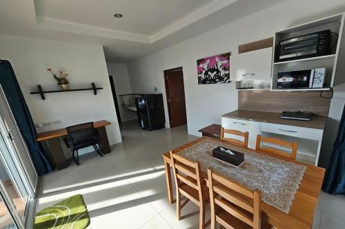 a kitchen and dining room with a table and chairs at The One Cozy Vacation Residence SHA Hotel in Chalong 