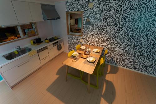 a kitchen with a wooden table in a room at THE LOBS, RUSUTSU in Kimobetsu