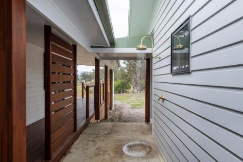 a hallway leading into a house with a door at Farmstay - LJHooker Yamba in Maclean