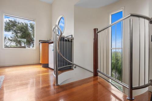 an empty room with a staircase and a window at Surf View - WiFi Included in Inverloch