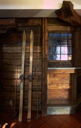 a wall with two skis and a window in a room at Hotel Milleluci in Aosta