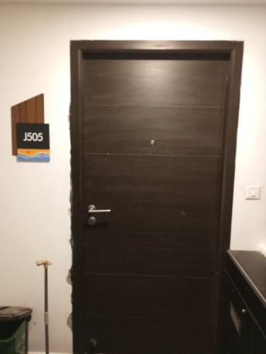 a black door in a room next to a wall at Ranga Vila’s on ECR in Chennai