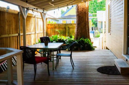 a patio with a table and chairs on a wooden floor at Clinton Studio in Lafayette